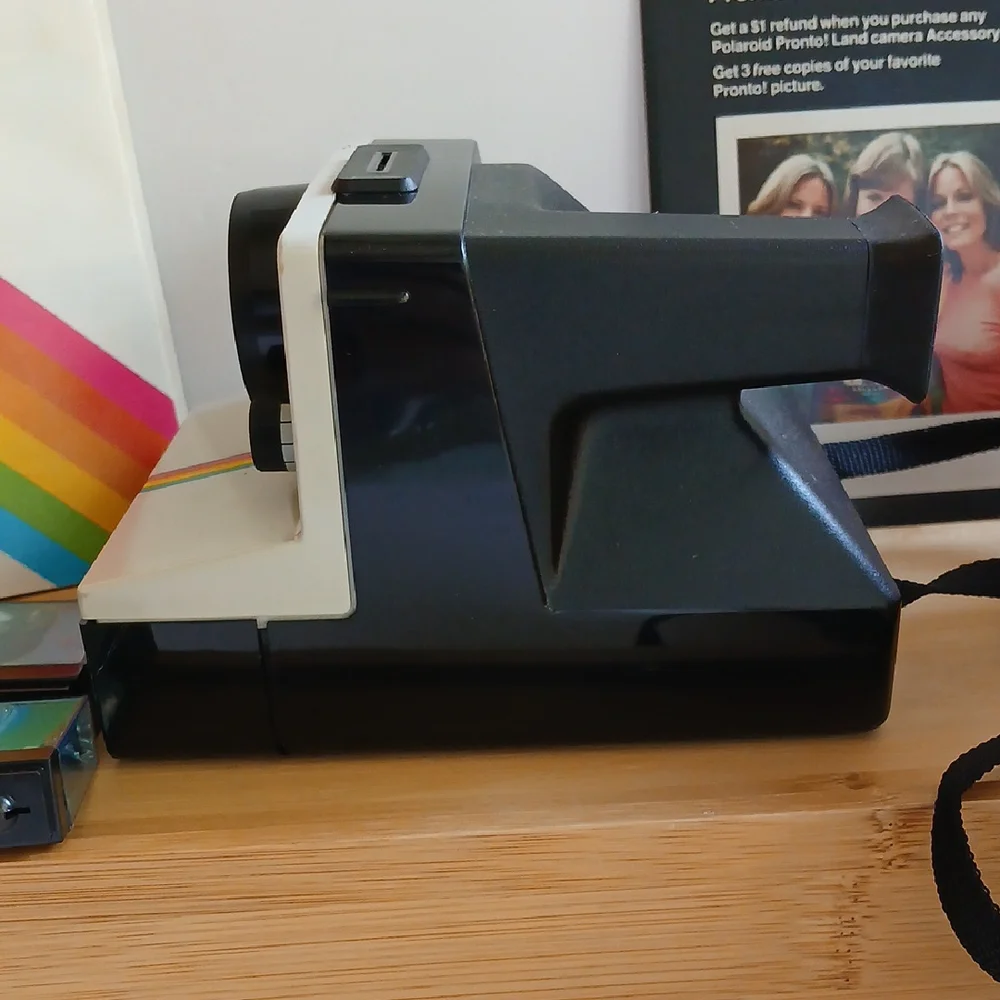 Vintage Polaroid Land One Step Instant Film Camera with Iconic Rainbow Design